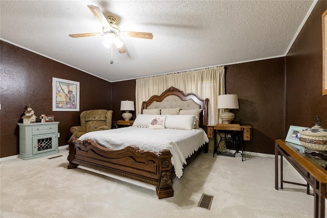 711 Sisson Ave, Sayre, OK 73662 - carpeted bedroom featuring a textured ceiling, a textured wall, crown molding, vaulted ceiling, and ceiling fan