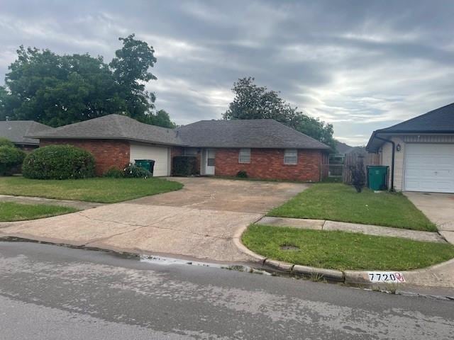 7716 S Charlotte Dr, Oklahoma City, OK 73159 - ranch-style house featuring concrete driveway, a front lawn, an attached garage, and brick siding