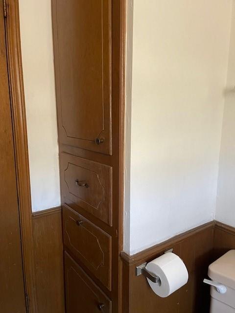 7716 S Charlotte Dr, Oklahoma City, OK 73159 - half bathroom with toilet and wainscoting