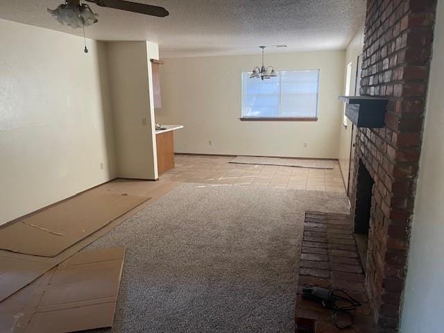 7716 S Charlotte Dr, Oklahoma City, OK 73159 - unfurnished living room with a fireplace, a textured ceiling, a chandelier, light carpet, and ceiling fan