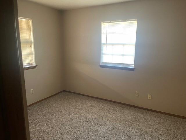 7716 S Charlotte Dr, Oklahoma City, OK 73159 - carpeted spare room featuring baseboards