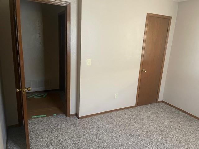 7716 S Charlotte Dr, Oklahoma City, OK 73159 - empty room featuring baseboards and carpet floors