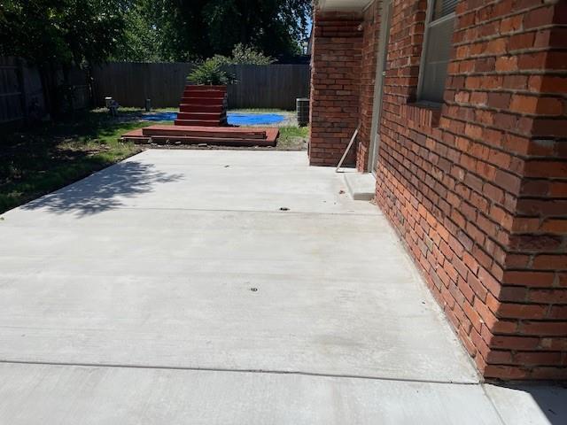 7716 S Charlotte Dr, Oklahoma City, OK 73159 - fenced backyard with a patio