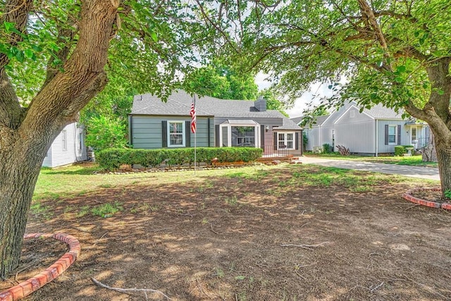 1016 E Cypress St, Altus, OK 73521 - single story home featuring a chimney, driveway, and a shingled roof