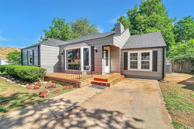 1016 E Cypress St, Altus, OK 73521 - view of front of house with a shingled roof and a chimney