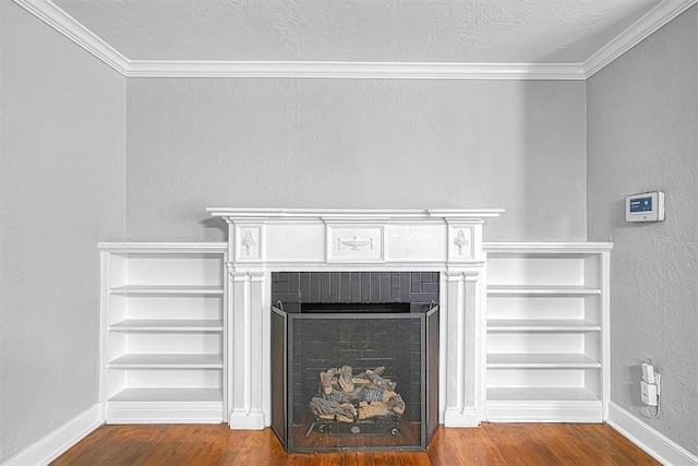 1016 E Cypress St, Altus, OK 73521 - detailed view of wood finished floors, ornamental molding, baseboards, a fireplace, and a textured wall