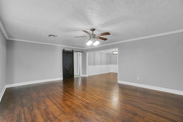 1016 E Cypress St, Altus, OK 73521 - empty room with ceiling fan, a barn door, hardwood / wood-style floors, a textured ceiling, and baseboards