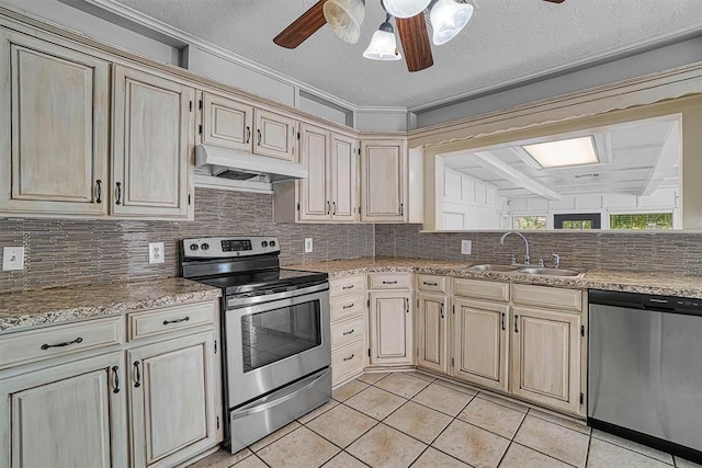 1016 E Cypress St, Altus, OK 73521 - kitchen featuring appliances with stainless steel finishes, under cabinet range hood, a sink, and cream cabinetry