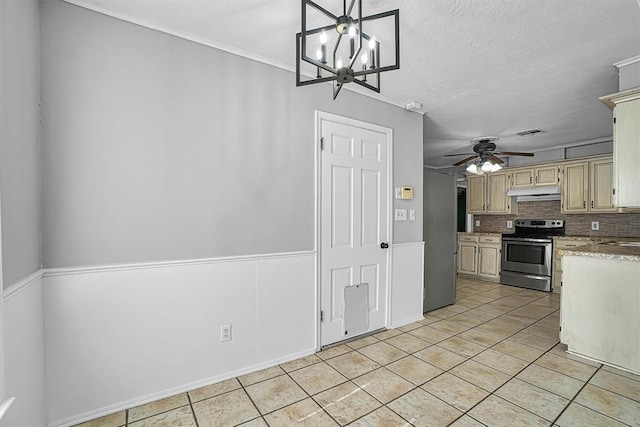 1016 E Cypress St, Altus, OK 73521 - kitchen with electric range, under cabinet range hood, light tile patterned floors, backsplash, and light countertops