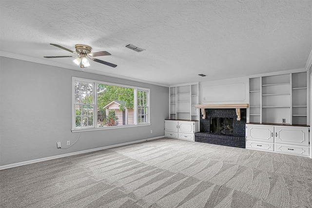 1016 E Cypress St, Altus, OK 73521 - unfurnished living room featuring a textured ceiling, carpet floors, ceiling fan, baseboards, and crown molding