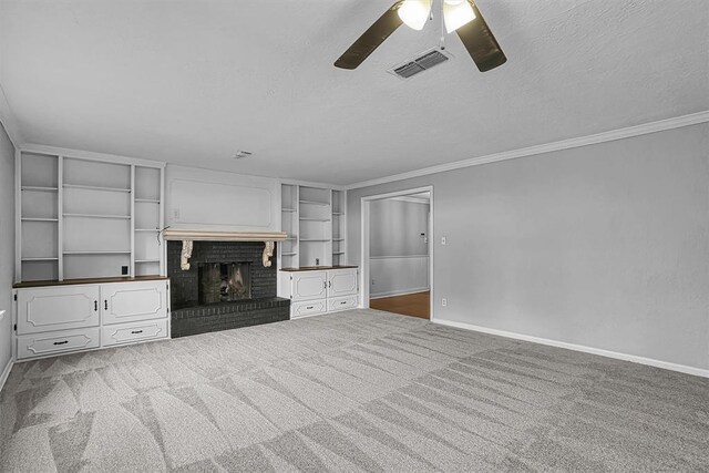 1016 E Cypress St, Altus, OK 73521 - unfurnished living room with ceiling fan, baseboards, a fireplace, a textured ceiling, and crown molding