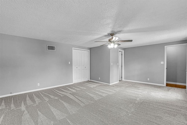 1016 E Cypress St, Altus, OK 73521 - spare room with ceiling fan, carpet floors, a textured ceiling, and baseboards