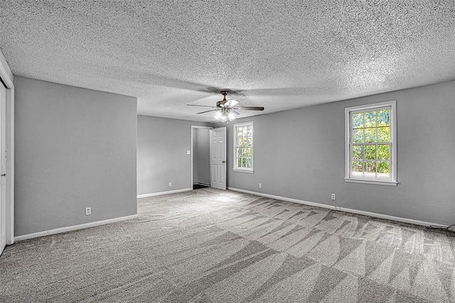 1016 E Cypress St, Altus, OK 73521 - unfurnished room featuring plenty of natural light, a ceiling fan, carpet floors, baseboards, and a textured ceiling