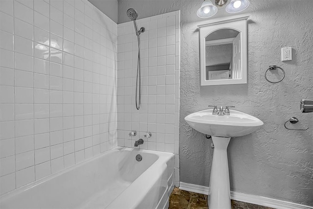 1016 E Cypress St, Altus, OK 73521 - full bath featuring a textured wall, baseboards, bathtub / shower combination, and a sink