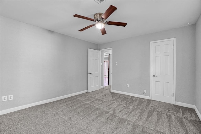 1016 E Cypress St, Altus, OK 73521 - unfurnished bedroom with carpet floors, baseboards, and ceiling fan