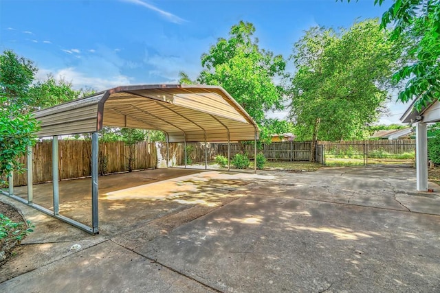 1016 E Cypress St, Altus, OK 73521 - view of parking / parking lot featuring a carport and concrete driveway