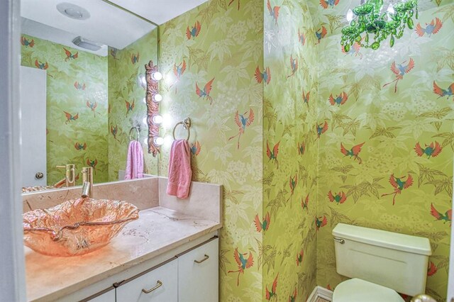3605 Hampton Ct, Norman, OK 73072 - half bath featuring vanity, wallpapered walls, and toilet
