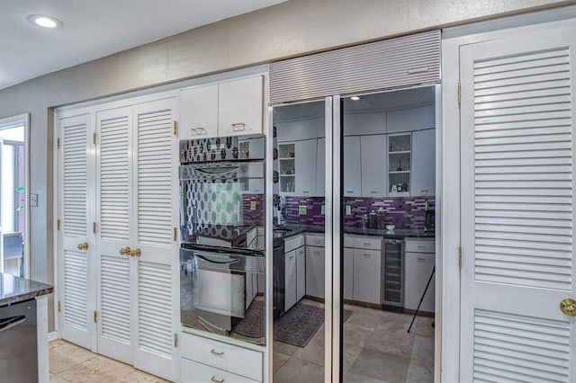 3605 Hampton Ct, Norman, OK 73072 - kitchen with dishwasher, white cabinets, beverage cooler, light tile patterned flooring, and decorative backsplash