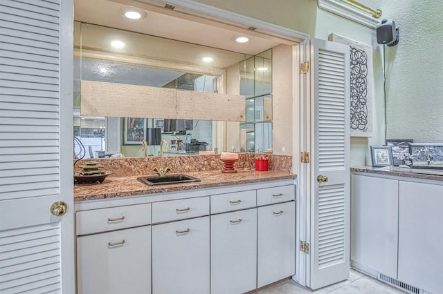 3605 Hampton Ct, Norman, OK 73072 - bathroom featuring vanity, a textured wall, and tile patterned floors