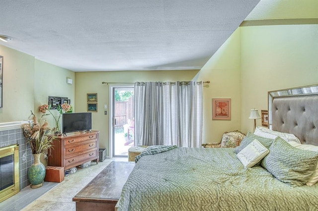 3605 Hampton Ct, Norman, OK 73072 - bedroom with access to outside, a textured ceiling, and a tiled fireplace