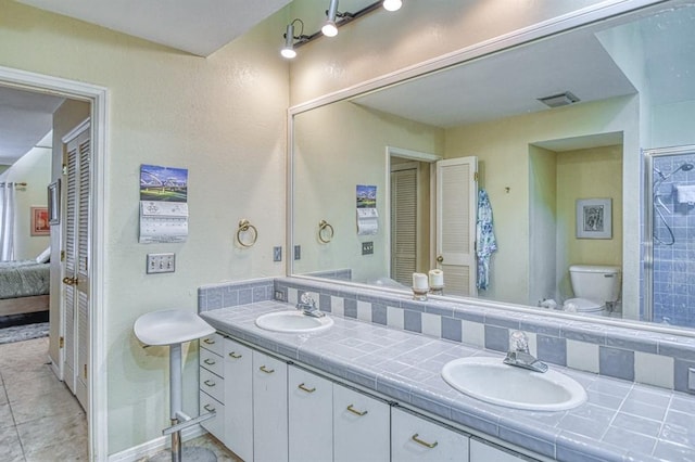 3605 Hampton Ct, Norman, OK 73072 - bathroom with double vanity, toilet, and ensuite bath