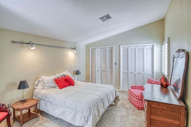 3605 Hampton Ct, Norman, OK 73072 - bedroom featuring vaulted ceiling, two closets, and carpet floors