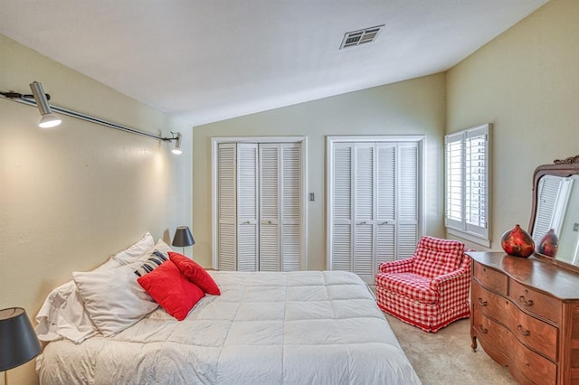 3605 Hampton Ct, Norman, OK 73072 - bedroom with vaulted ceiling, multiple closets, and light carpet