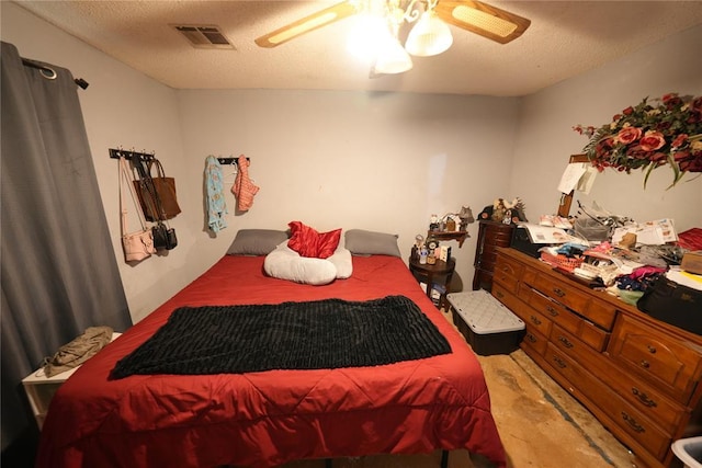 bedroom with a textured ceiling and ceiling fan