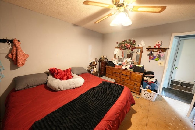 bedroom featuring a ceiling fan and a textured ceiling