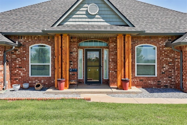 13131 SW 15th St, Yukon, OK 73099 - doorway to property featuring brick siding, roof with shingles, a yard, and covered porch