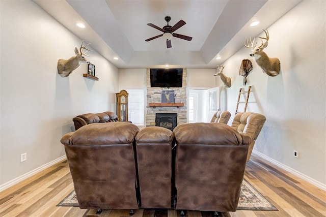 13131 SW 15th St, Yukon, OK 73099 - living room featuring a ceiling fan, baseboards, a stone fireplace, light wood finished floors, and recessed lighting