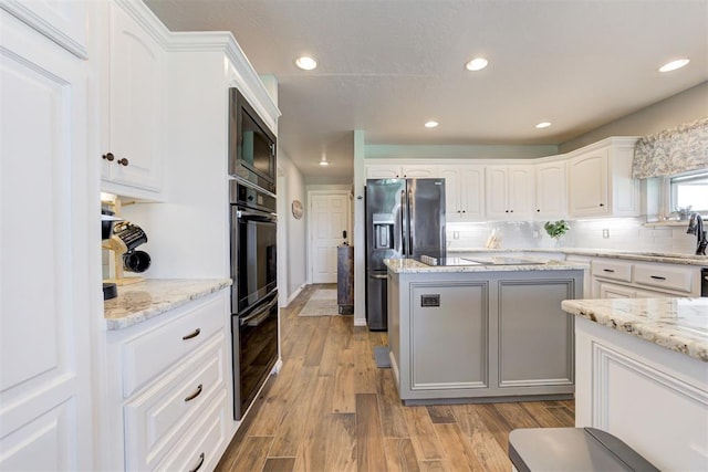 13131 SW 15th St, Yukon, OK 73099 - kitchen with black appliances, a sink, decorative backsplash, wood finished floors, and recessed lighting