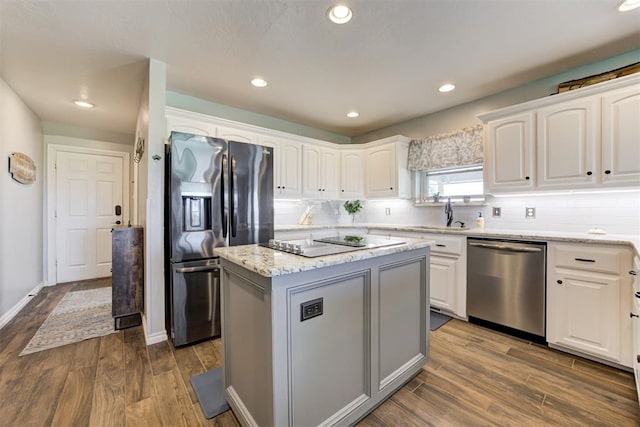 13131 SW 15th St, Yukon, OK 73099 - kitchen featuring stainless steel dishwasher, fridge with ice dispenser, a kitchen island, white cabinetry, and recessed lighting