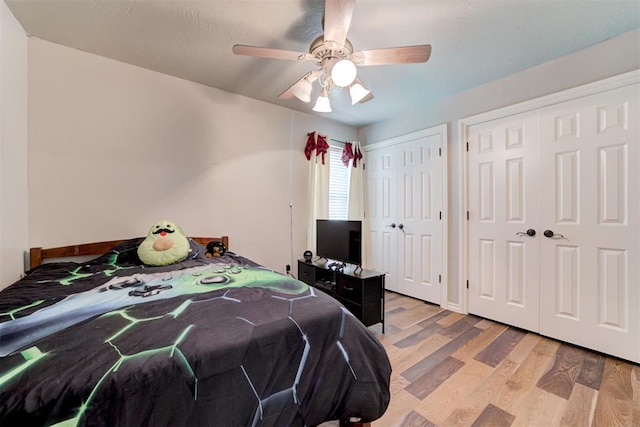 13131 SW 15th St, Yukon, OK 73099 - bedroom with two closets, light wood-style floors, and ceiling fan