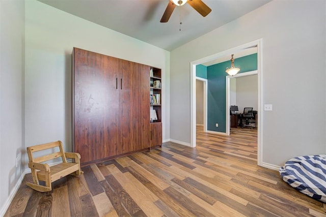 13131 SW 15th St, Yukon, OK 73099 - bedroom with a desk, wood finished floors, and baseboards