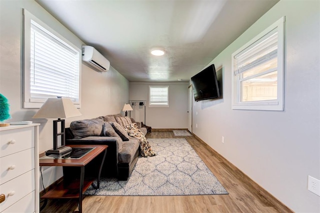 13131 SW 15th St, Yukon, OK 73099 - living room featuring an AC wall unit and light wood-style floors