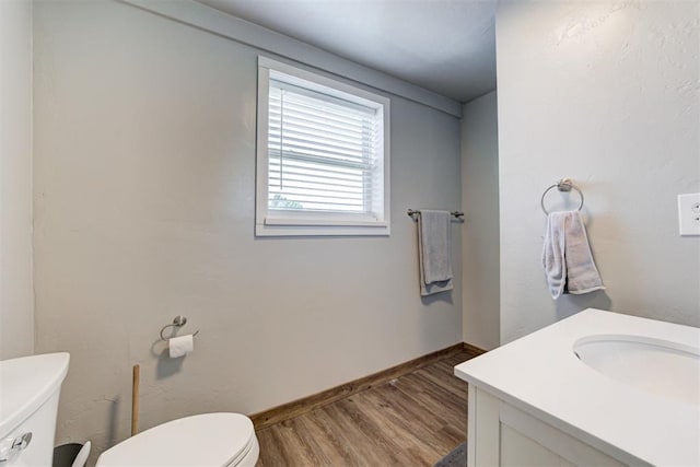 13131 SW 15th St, Yukon, OK 73099 - bathroom featuring toilet, wood finished floors, vanity, and baseboards