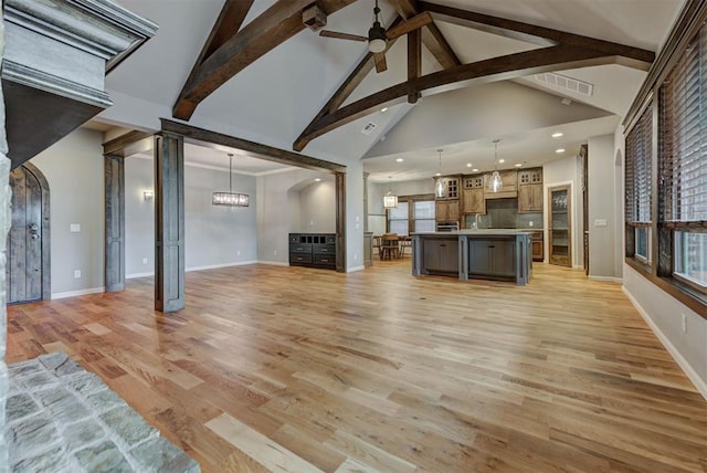 1440 Station St, Edmond, OK 73034 - unfurnished living room with ceiling fan, baseboards, light wood-type flooring, recessed lighting, and beam ceiling