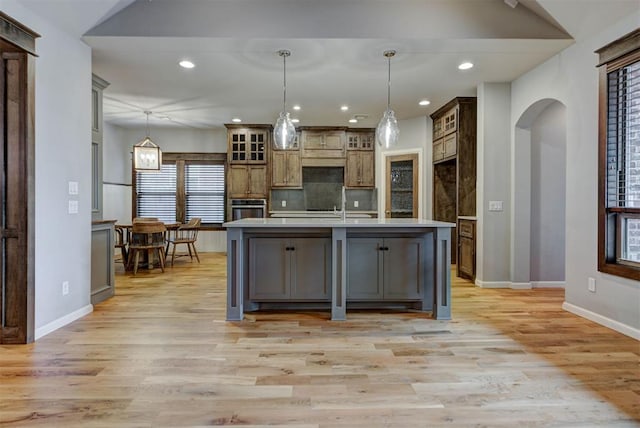 1440 Station St, Edmond, OK 73034 - kitchen featuring stainless steel oven, light countertops, arched walkways, recessed lighting, and baseboards