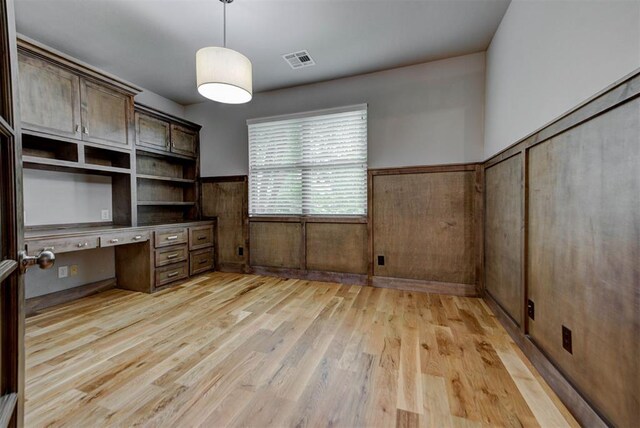 1440 Station St, Edmond, OK 73034 - unfurnished office with built in study area, light wood finished floors, and wainscoting