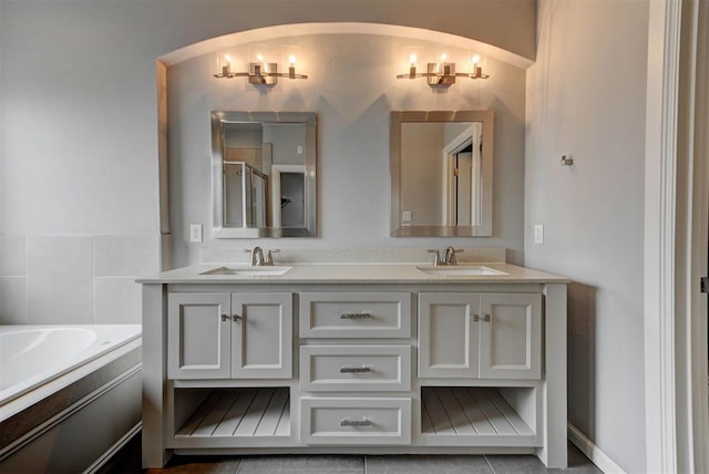 1440 Station St, Edmond, OK 73034 - bathroom featuring double vanity, a garden tub, and a shower with shower door