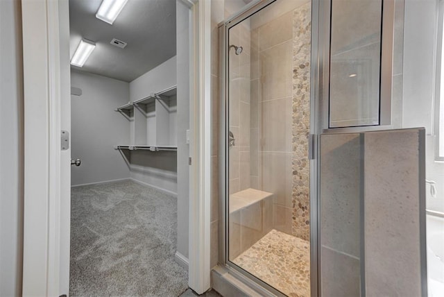 1440 Station St, Edmond, OK 73034 - full bath featuring a stall shower, a walk in closet, and baseboards
