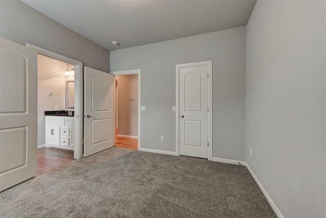 1440 Station St, Edmond, OK 73034 - unfurnished bedroom featuring carpet floors, a sink, and baseboards