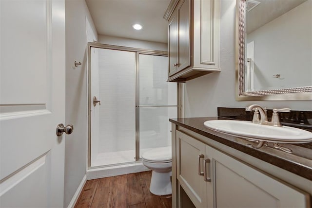 1440 Station St, Edmond, OK 73034 - bathroom with toilet, vanity, a stall shower, wood finished floors, and recessed lighting