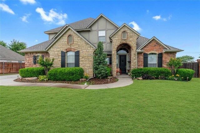 13605 Verona Strada, Oklahoma City, OK 73170 - view of front of house with stone siding, stucco siding, and a shingled roof