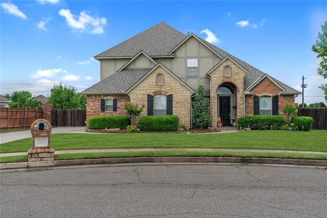 13605 Verona Strada, Oklahoma City, OK 73170 - english style home featuring a shingled roof, stone siding, stucco siding, and concrete driveway