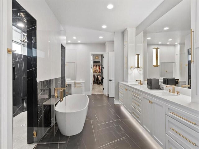 12901 Rivendell Dr, Oklahoma City, OK 73170 - full bathroom with a freestanding bath, double vanity, recessed lighting, a walk in closet, and a stall shower