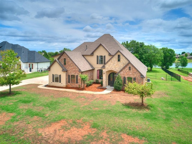 15228 Turtle Lake Pl, Oklahoma City, OK 73165 - french country home with stone siding, stucco siding, and a shingled roof