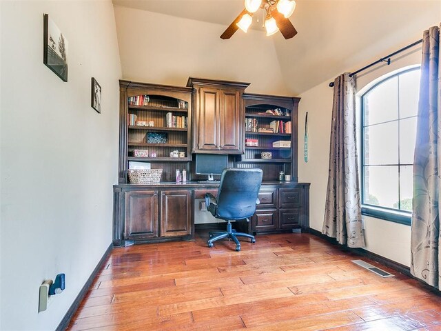 15228 Turtle Lake Pl, Oklahoma City, OK 73165 - office with lofted ceiling, built in desk, ceiling fan, light wood-type flooring, and baseboards