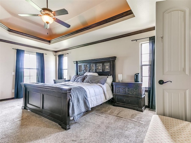 15228 Turtle Lake Pl, Oklahoma City, OK 73165 - carpeted bedroom featuring a tray ceiling, multiple windows, crown molding, and a ceiling fan